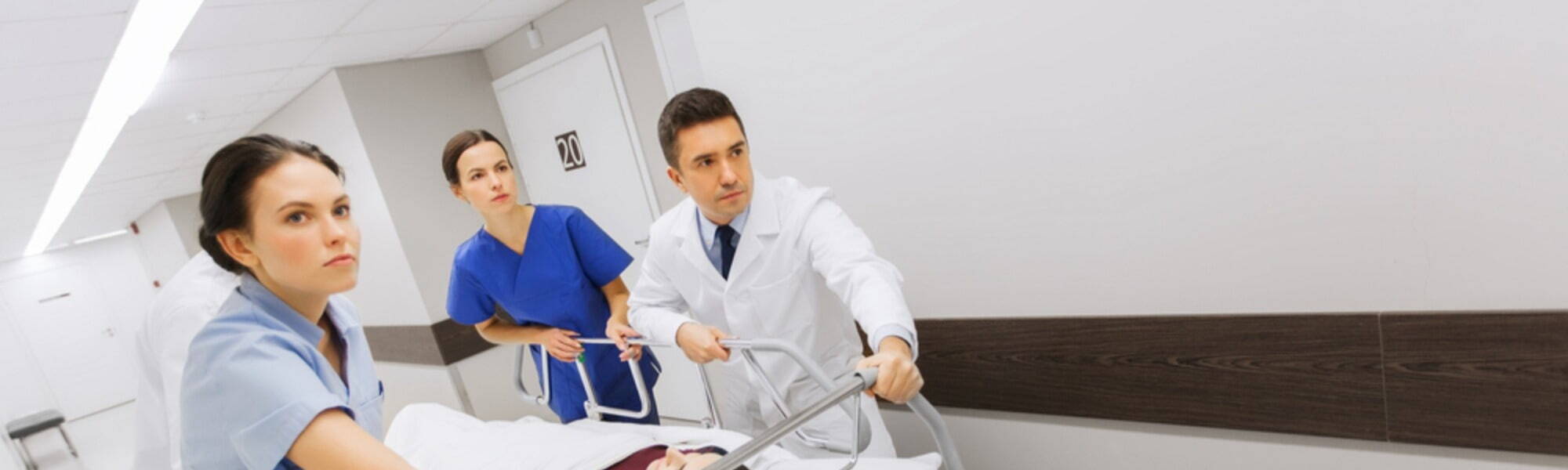 nurses doctors pushing a patient in hospital